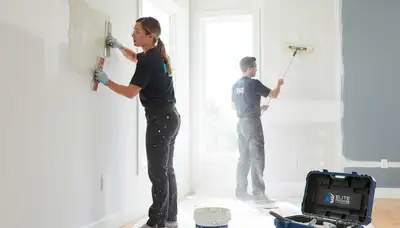 Technician repairing drywall cracks in Omaha, NE home during professional wall restoration service